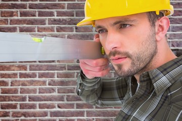 Poster - Composite image of carpenter using spirit level