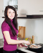 © JackF - woman frying seafood in pan at  kitchen