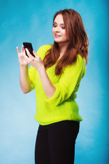 Wall Mural - Teenage girl with mobile phone texting