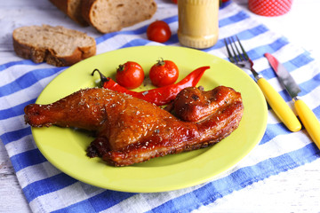 Poster - Smoked chicken leg  with vegetables on plate on table close up