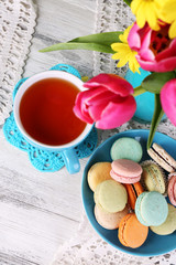 Wall Mural - Composition of spring flowers, tea and cookies on table