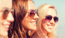 Close Up Of Smiling Young Women In Sunglasses