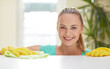 © Syda Productions - happy woman cleaning table at home kitchen