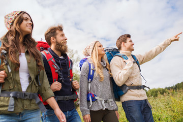 Sticker - group of smiling friends with backpacks hiking