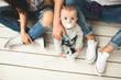 © katie_martynova - Young hipster father, mother and baby boy on wooden floor