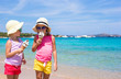 © travnikovstudio - Little happy girls eating ice cream on tropical beach