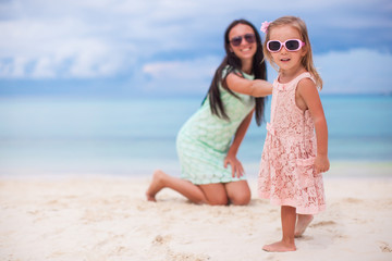 Little girl and happy mom during summer vacation