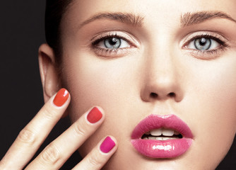 Beautiful young model with bright make-up and manicure