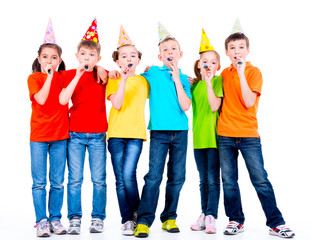 Group of happy children with party blowers.