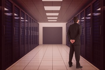 Poster - Composite image of businessman standing and looking