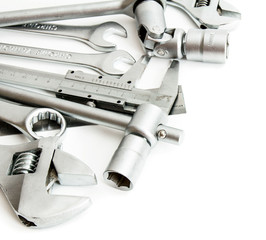 Metalwork. Spanner , ruler, caliper and others tools on white