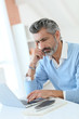 © goodluz - Trendy mature man working from home with laptop
