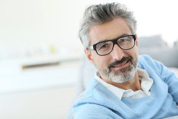 Wall Mural - Smiling mature man with grey hair wearing eyeglasses