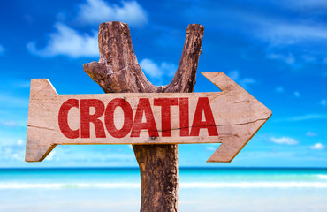 Wall Mural - Croatia wooden sign with a beach on background