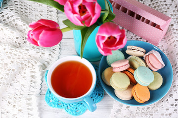 Wall Mural - Composition of spring flowers, tea and cookies on table