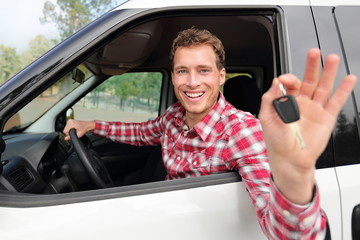 Wall Mural - Happy driving man showing new car keys or rental