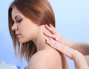 Doctor inspecting woman patient skin