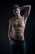 © theartofphoto - Handsome muscular shirtless young man standing smiling c