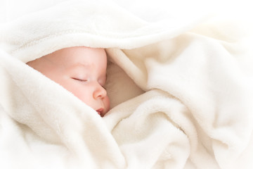 Baby sleeping covered with soft blanket