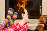 Fototapeta  - Feet warming by fireplace