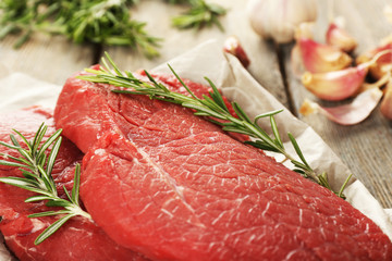 Canvas Print - Raw beef steak with rosemary and garlic