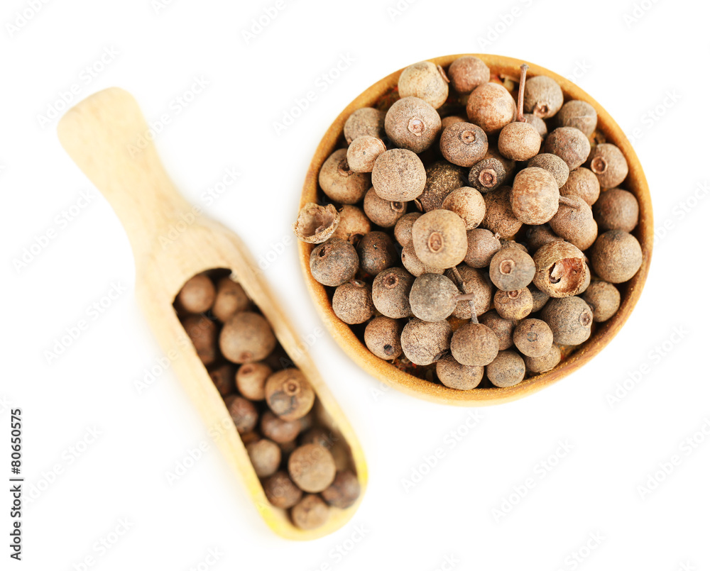 Allspice in wooden bowl, isolated on white