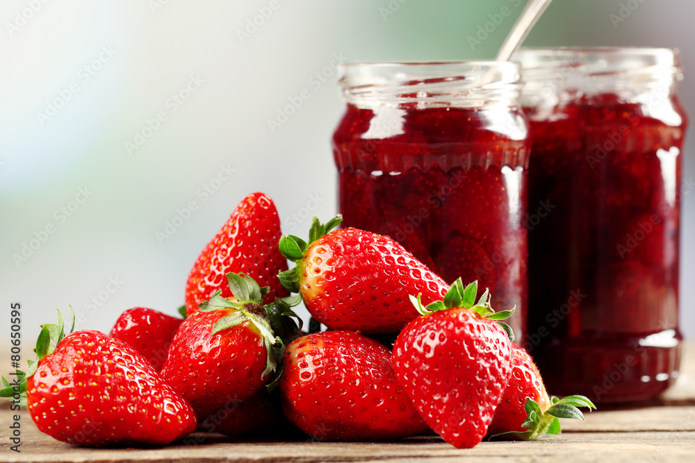 Jars of strawberry jam with berries