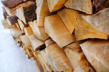 Firewood In Snow Outdoors, Closeup
