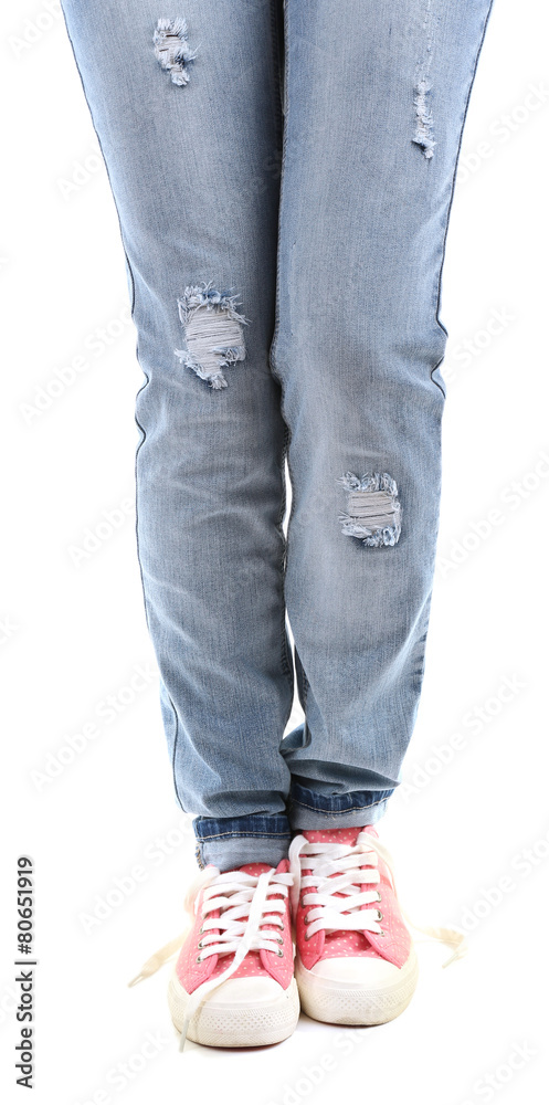 Human legs in jeans and shoes isolated on white