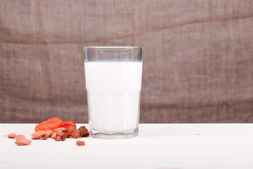 Sticker - milk, almonds, raisins, dried apricots on the table side view