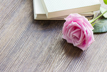 Pink Rose Flower And Book On The Wood