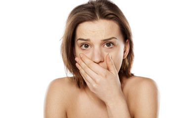 shocked and frightened girl on a white background