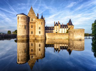 Sticker - Chateau of Sully-sur-Loire, France. Old medieval French castle on river at sunset in summer.