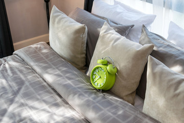 Sticker - modern bedroom with green alarm clock and pillows on bed