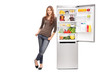 © Ljupco Smokovski - Casual young girl leaning on an opened refrigerator