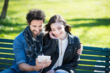 Wall Mural - couple enjoying music together