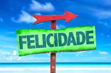 Happiness (in Portuguese) sign with beach background