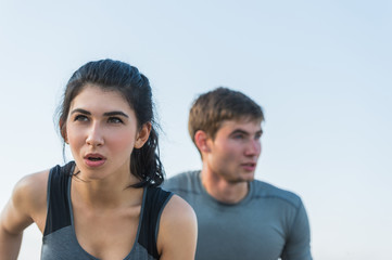 Cheerful Hispanic Caucasian couple running