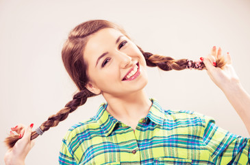 playful teen girl with pigtails