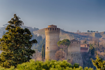 Poster - Medieval  Fortress and clock tower among hills in the fog