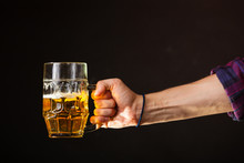 Male Hand Holding Mug Of Beer
