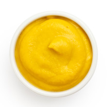 American Yellow Mustard In Round Dish From Above On White.