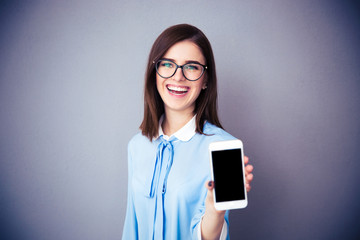 Canvas Print - Laughing businesswoman showing blank smartphone screen