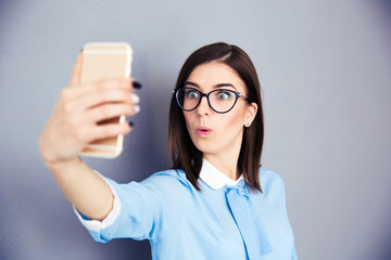 Wall Mural - Surprised businesswoman making selfie photo