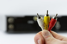 AV Cable Connectors In Hand With AV Receiver