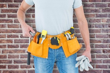 Poster - Composite image of technician holding gloves and hammer