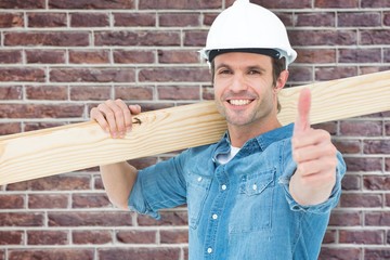 Poster - Composite image of confident carpenter carrying wooden plank