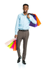 Happy african american man holding shopping bags on white backgr