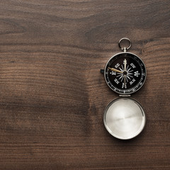 compass on the brown wooden table