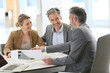 © goodluz - Mature couple meeting architect for construction project